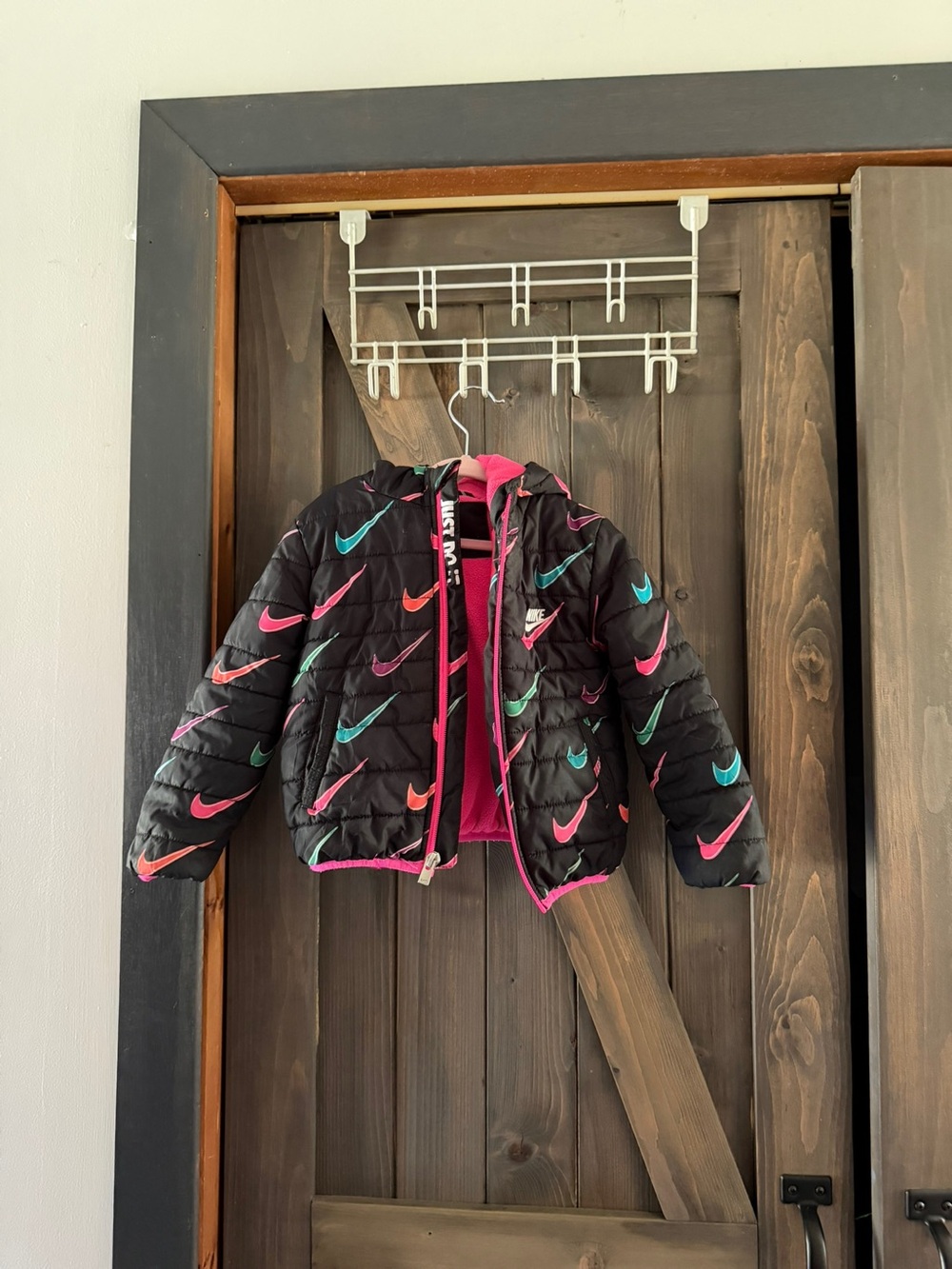 Nike Kids Black Puffer Jacket with Pink and Teal Swoosh Accents